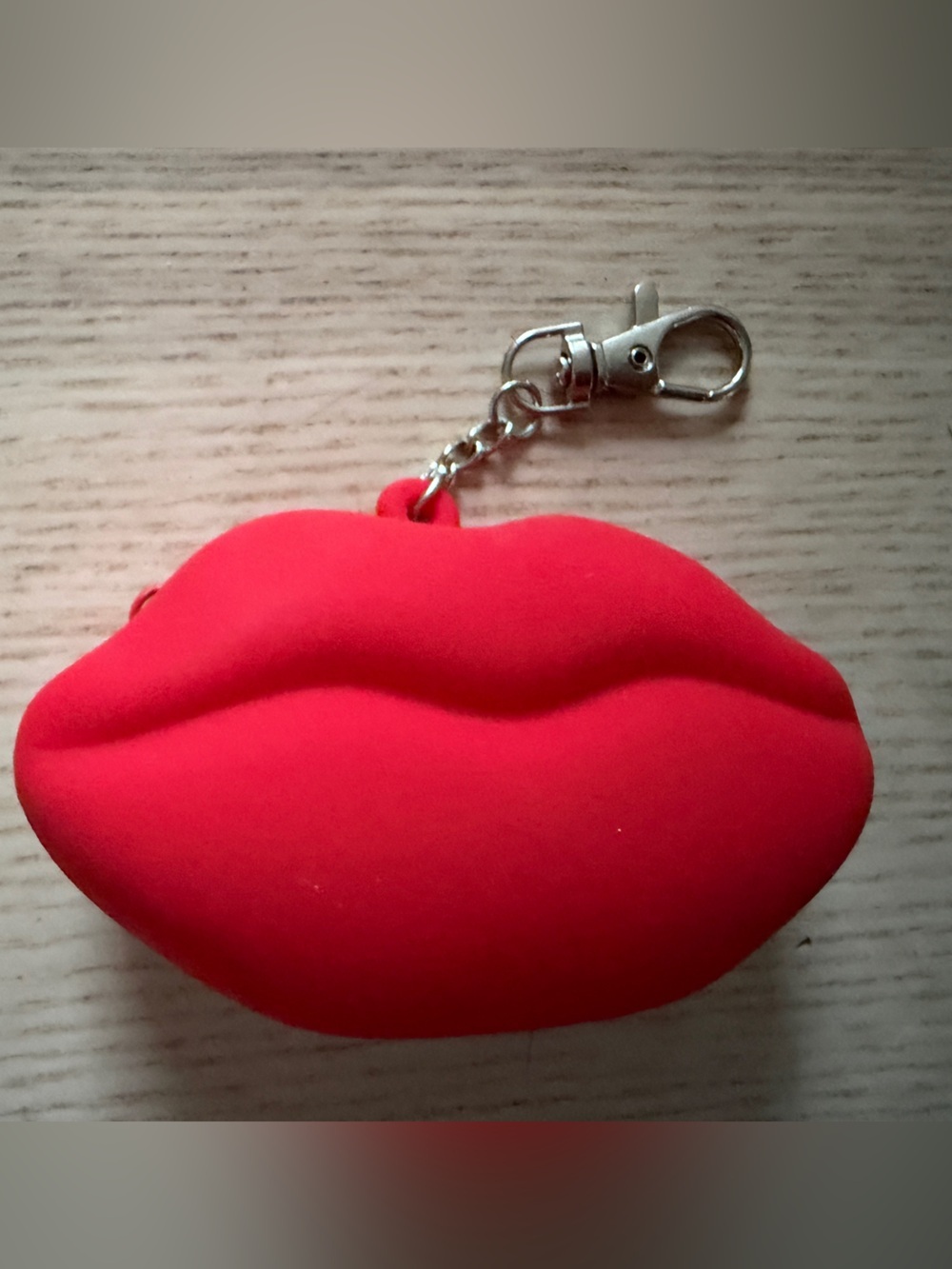 M·A·C Viva Glam silicone lip-shaped coin purse with key ring attached